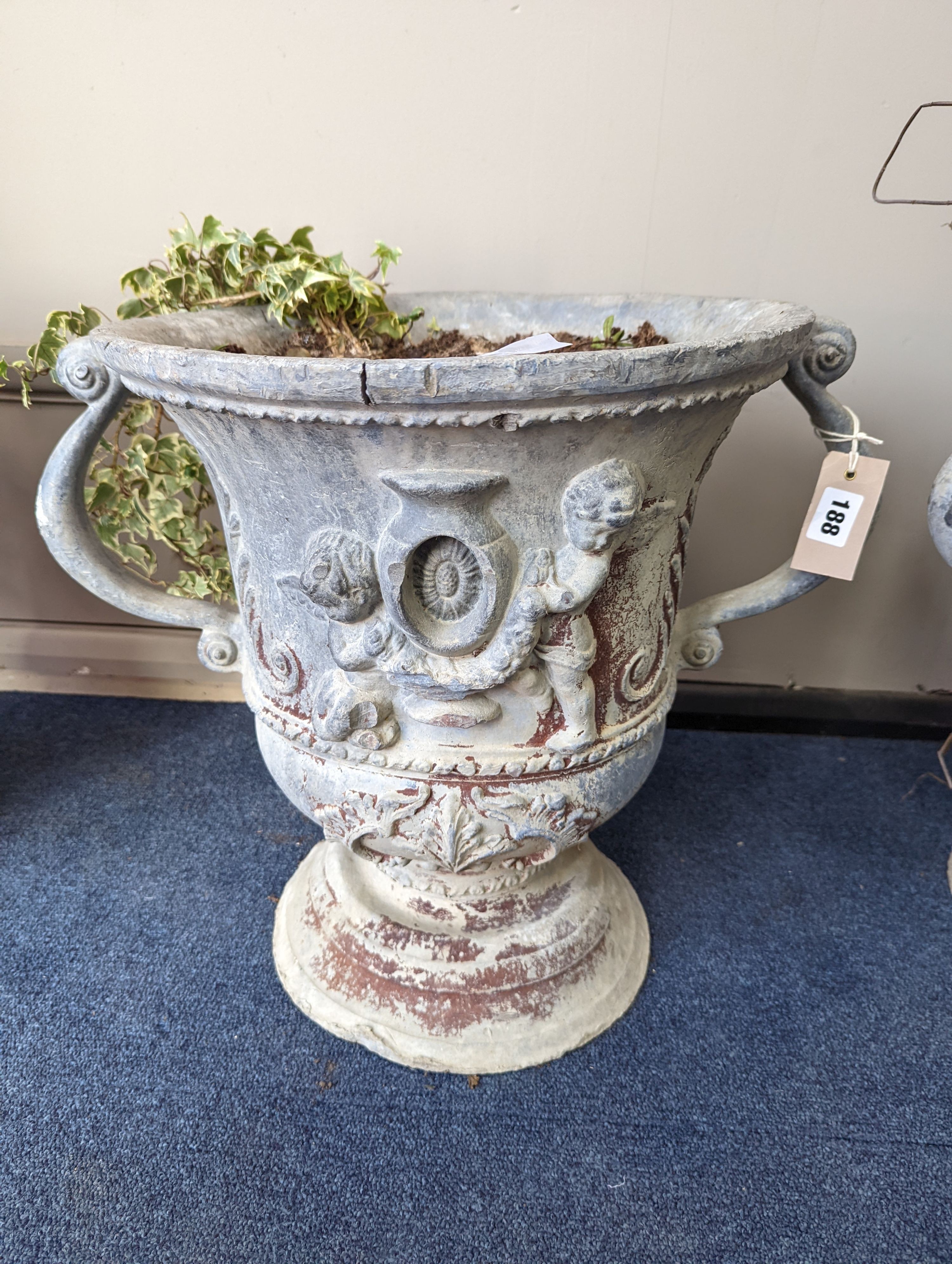 A set of three Victorian lead two handled garden planters, moulded with cherubs, diameter 38cm, height 43cm